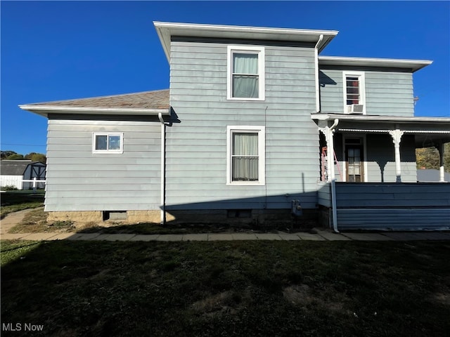 rear view of house with covered porch