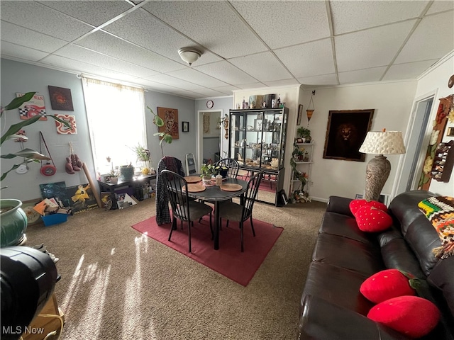 dining area featuring a drop ceiling and carpet floors