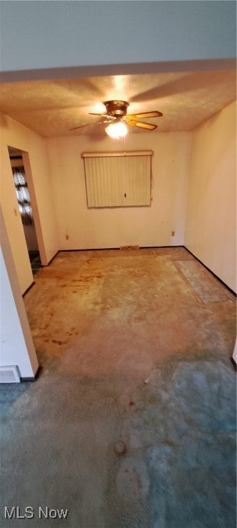 empty room featuring carpet flooring and ceiling fan