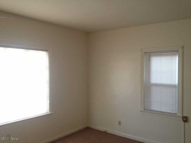 unfurnished room featuring carpet floors and plenty of natural light