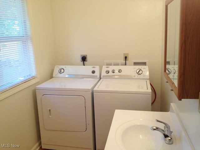 laundry area featuring sink and separate washer and dryer