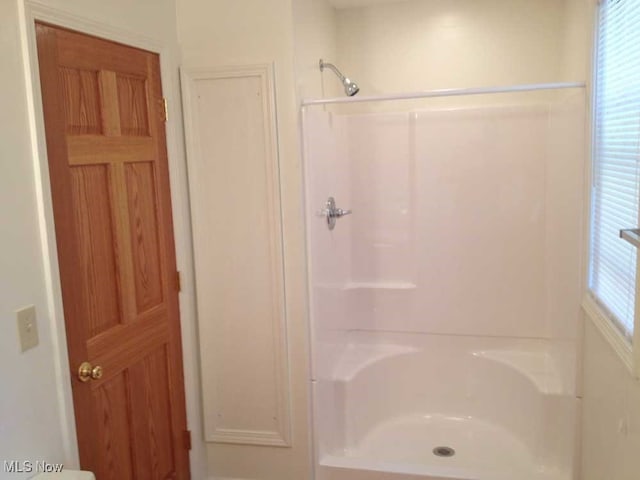 bathroom featuring separate shower and tub