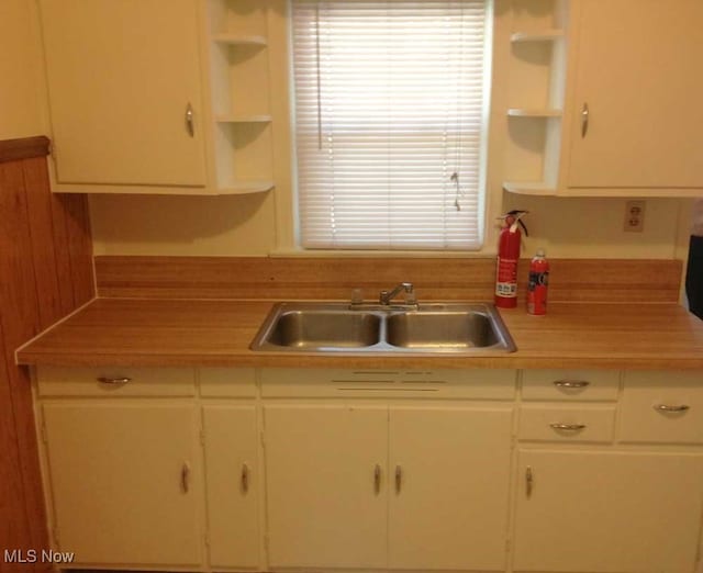 kitchen featuring sink and white cabinets