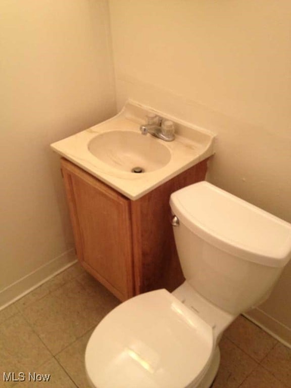 bathroom featuring vanity, toilet, and tile patterned floors