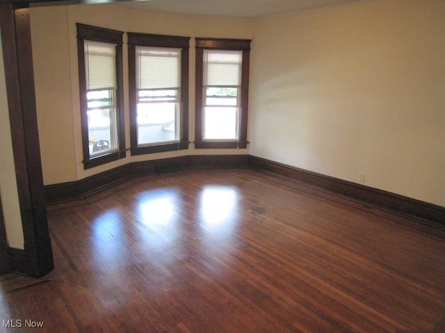 unfurnished room featuring hardwood / wood-style flooring