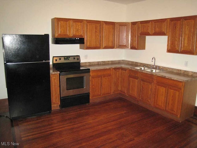 kitchen with stainless steel electric stove, dark hardwood / wood-style flooring, extractor fan, black refrigerator, and sink