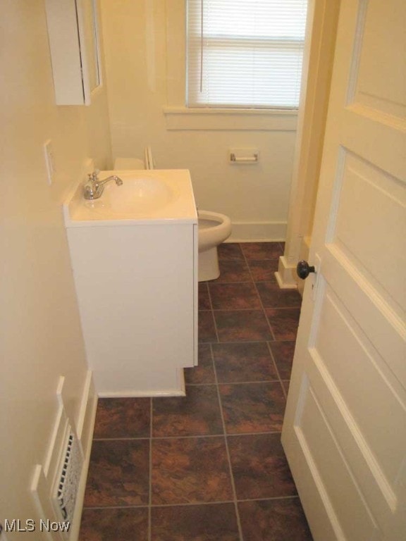 bathroom with vanity, toilet, and tile patterned flooring