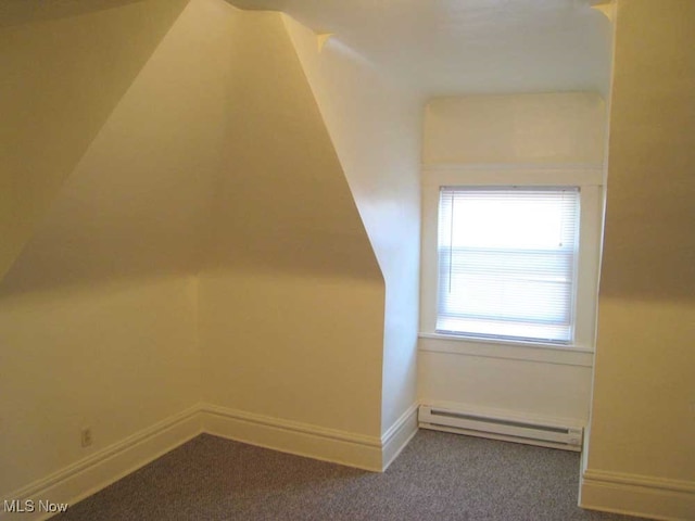 bonus room with a baseboard heating unit and carpet flooring