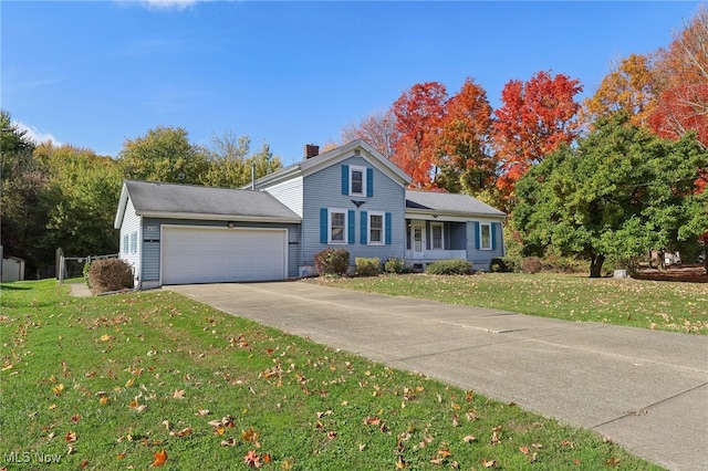 view of front of house with a front yard and a garage