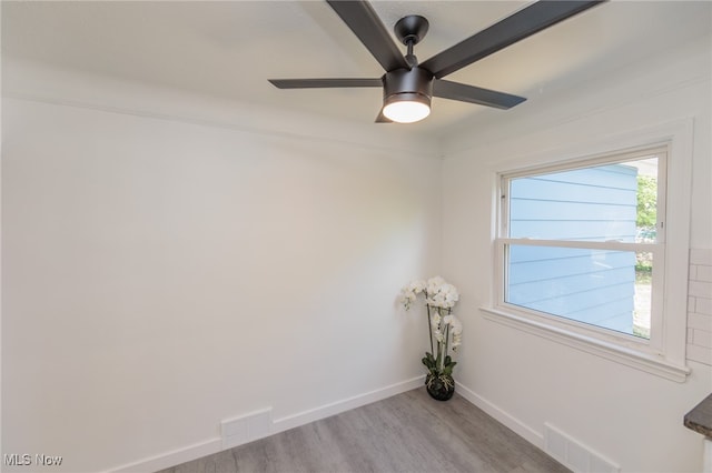 empty room with light hardwood / wood-style floors and ceiling fan