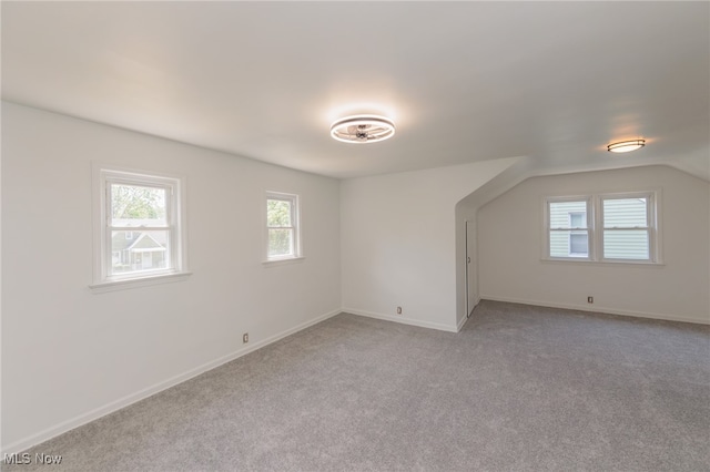 additional living space with light carpet and lofted ceiling