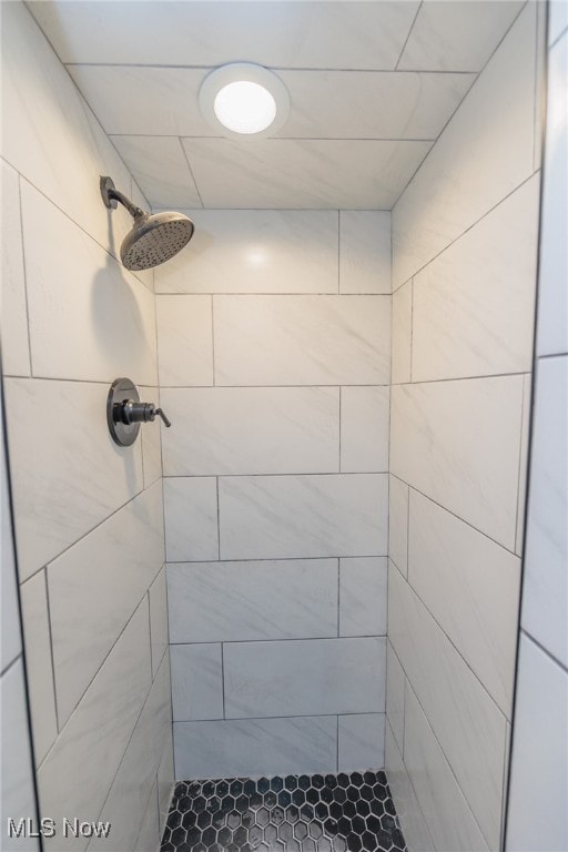 bathroom with a tile shower