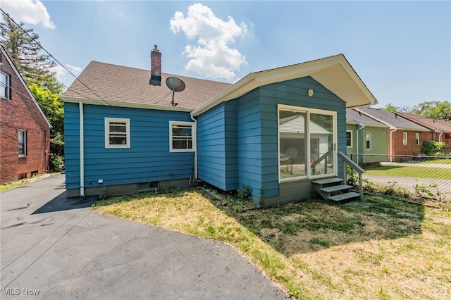 rear view of house with a yard