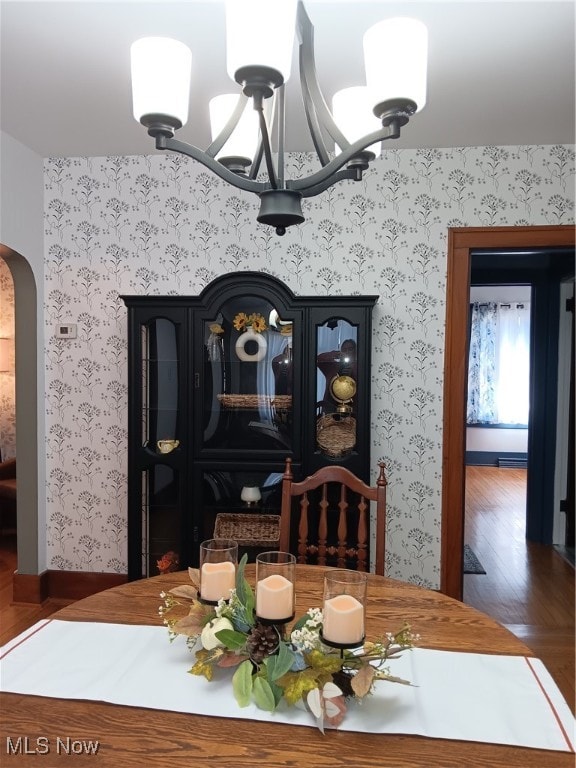 dining room featuring dark hardwood / wood-style flooring and a chandelier