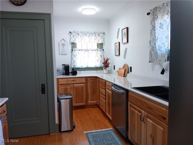 kitchen with stainless steel dishwasher and light hardwood / wood-style flooring