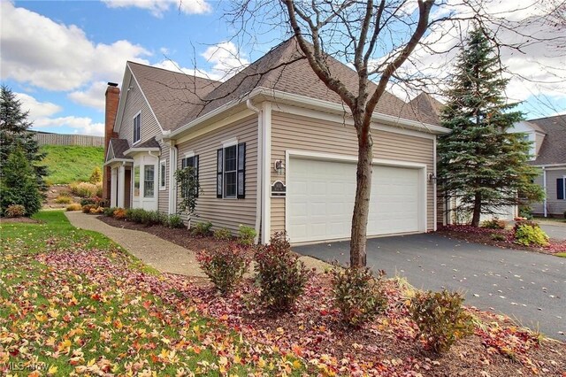 view of side of home featuring a garage