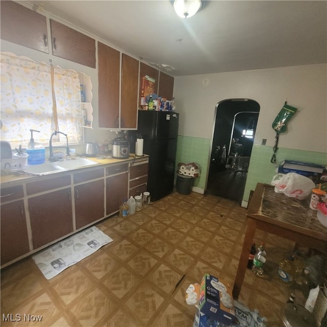 kitchen featuring sink and black fridge