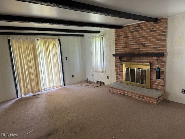 unfurnished living room with beam ceiling, carpet flooring, and a fireplace