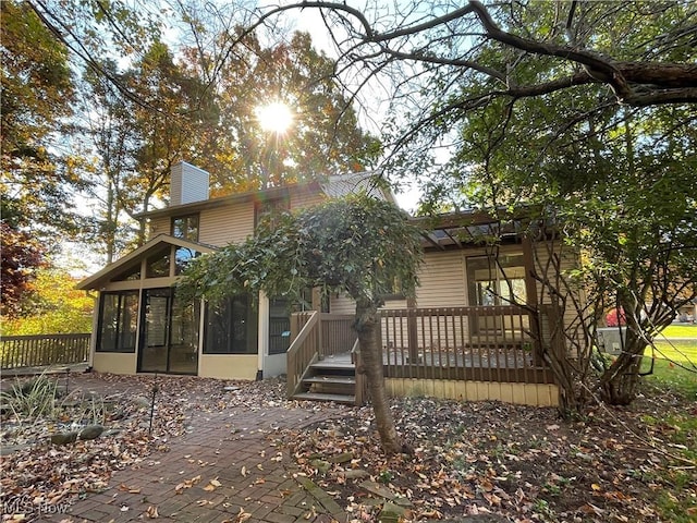 back of property featuring a sunroom