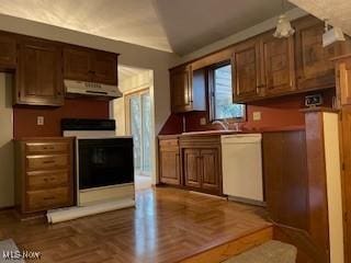 kitchen with white dishwasher, black range, dark parquet flooring, and extractor fan