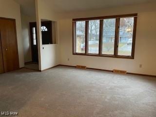 unfurnished living room featuring carpet