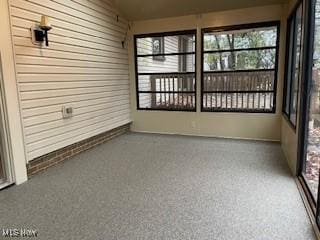 unfurnished sunroom featuring a wealth of natural light