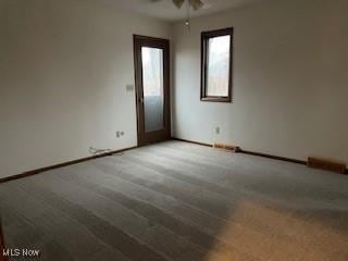 spare room with carpet flooring and ceiling fan