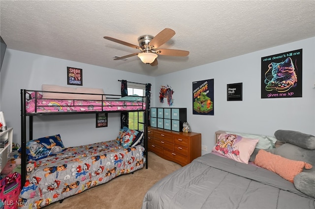 bedroom featuring carpet floors, a textured ceiling, and ceiling fan