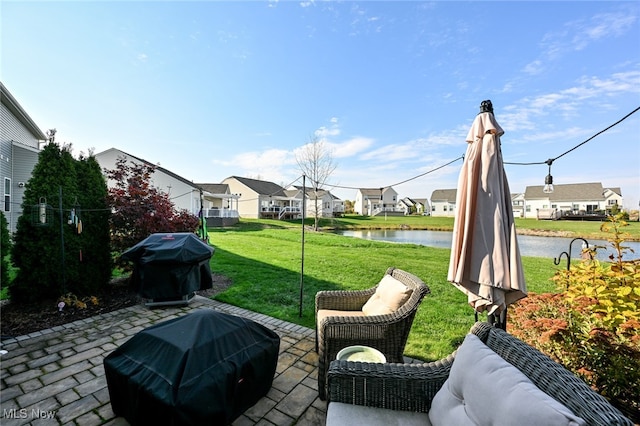 view of patio with a water view and grilling area