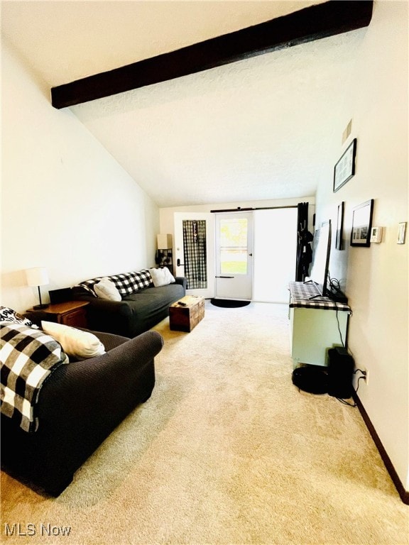 living room with vaulted ceiling with beams and carpet