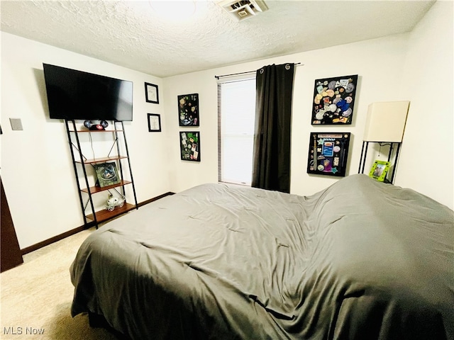 bedroom featuring carpet and a textured ceiling