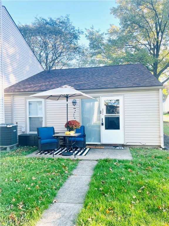 exterior space featuring central AC, a patio, and a lawn