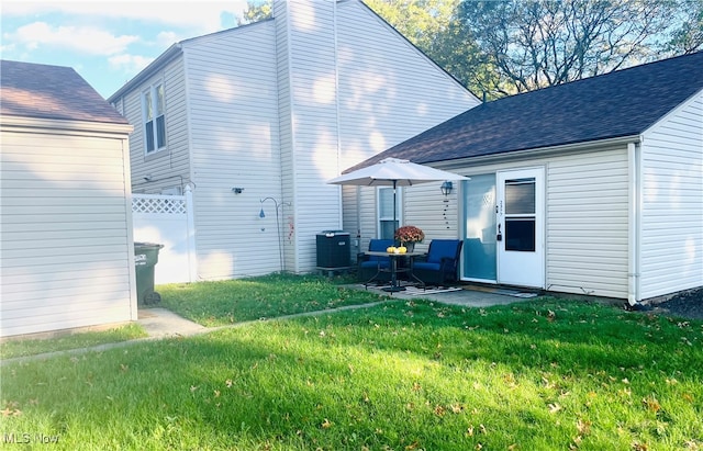 back of house featuring a patio and a lawn