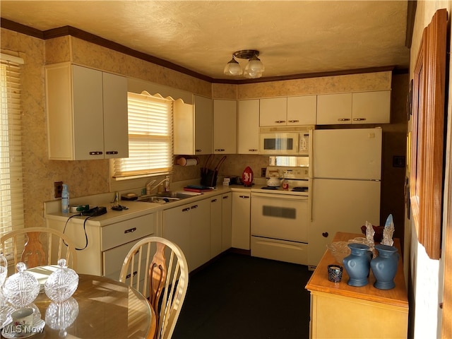 kitchen with a textured ceiling, sink, ornamental molding, white cabinetry, and white appliances