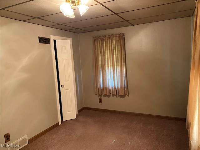 unfurnished room featuring a drop ceiling, carpet, and ceiling fan