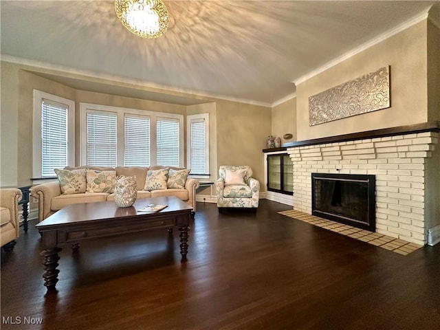 living room featuring wood-type flooring, a brick fireplace, and crown molding