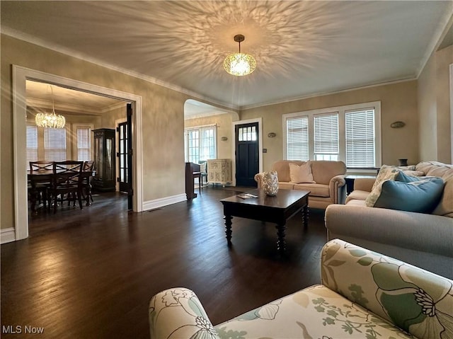 living room with ornamental molding, dark hardwood / wood-style floors, and a notable chandelier