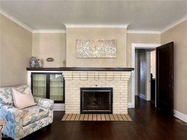 living room featuring crown molding, a fireplace, and dark hardwood / wood-style floors