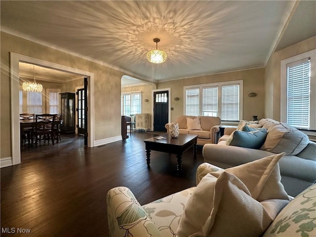 living room featuring dark hardwood / wood-style floors, an inviting chandelier, and a healthy amount of sunlight