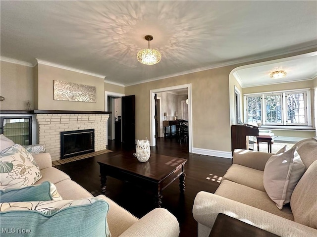 living room with a fireplace, dark hardwood / wood-style floors, and ornamental molding