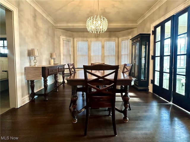 dining room with a chandelier, french doors, crown molding, and dark wood-type flooring