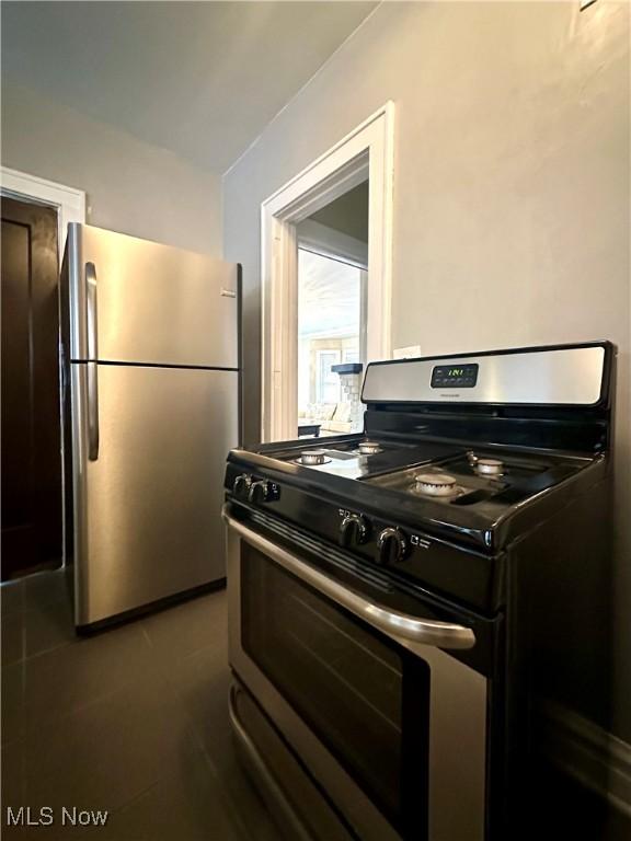 kitchen featuring gas range and stainless steel fridge