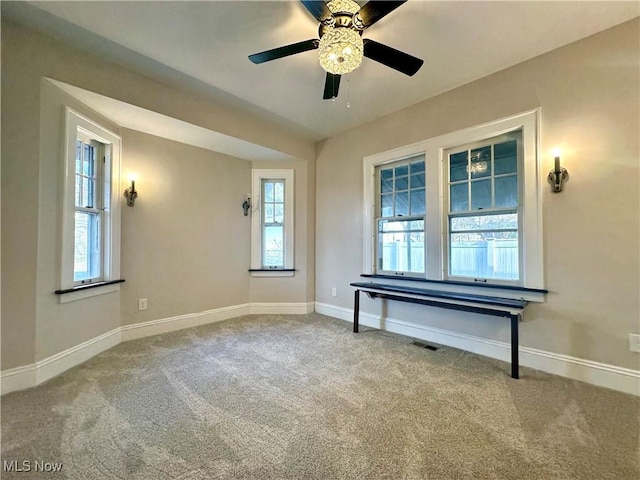 unfurnished room with ceiling fan and carpet floors