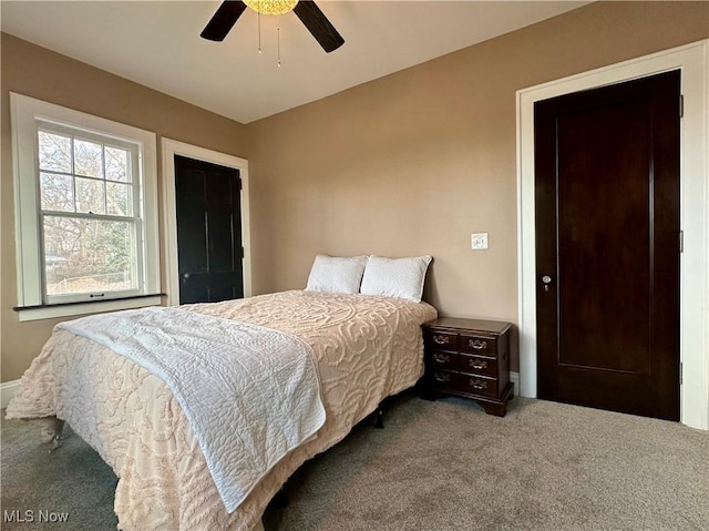 carpeted bedroom featuring ceiling fan