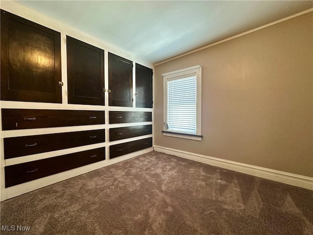 carpeted spare room with crown molding