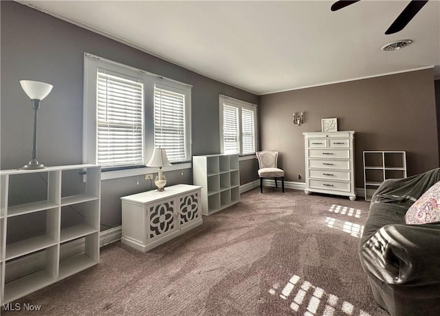 living area featuring carpet and ceiling fan