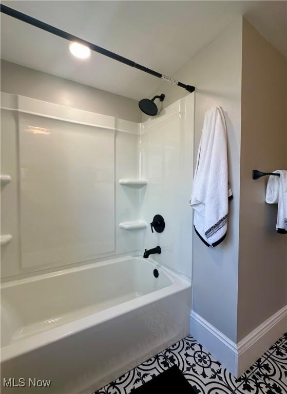 bathroom with tile patterned floors and bathtub / shower combination