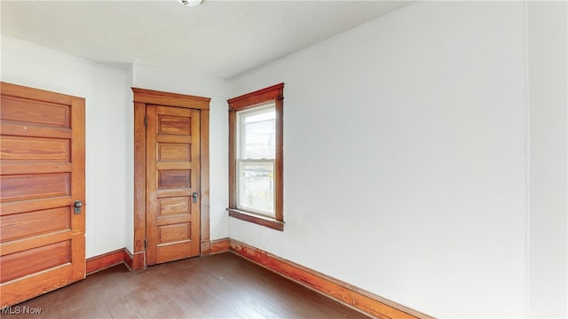 unfurnished bedroom with dark wood-type flooring