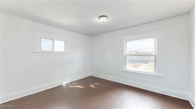 spare room with dark wood-type flooring