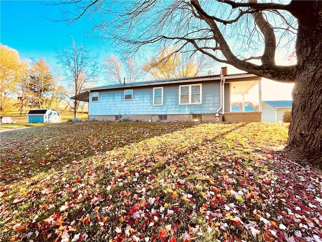 view of side of home featuring a shed